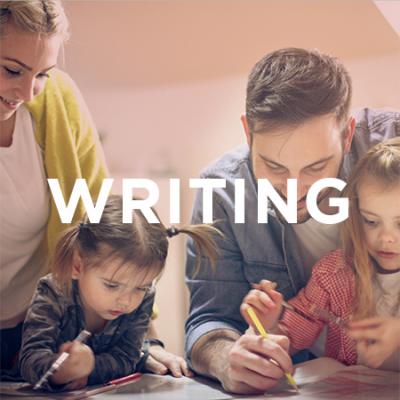 Photo of kids and parents writing together
