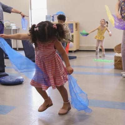 A child plays with scarves at Kids' Time.